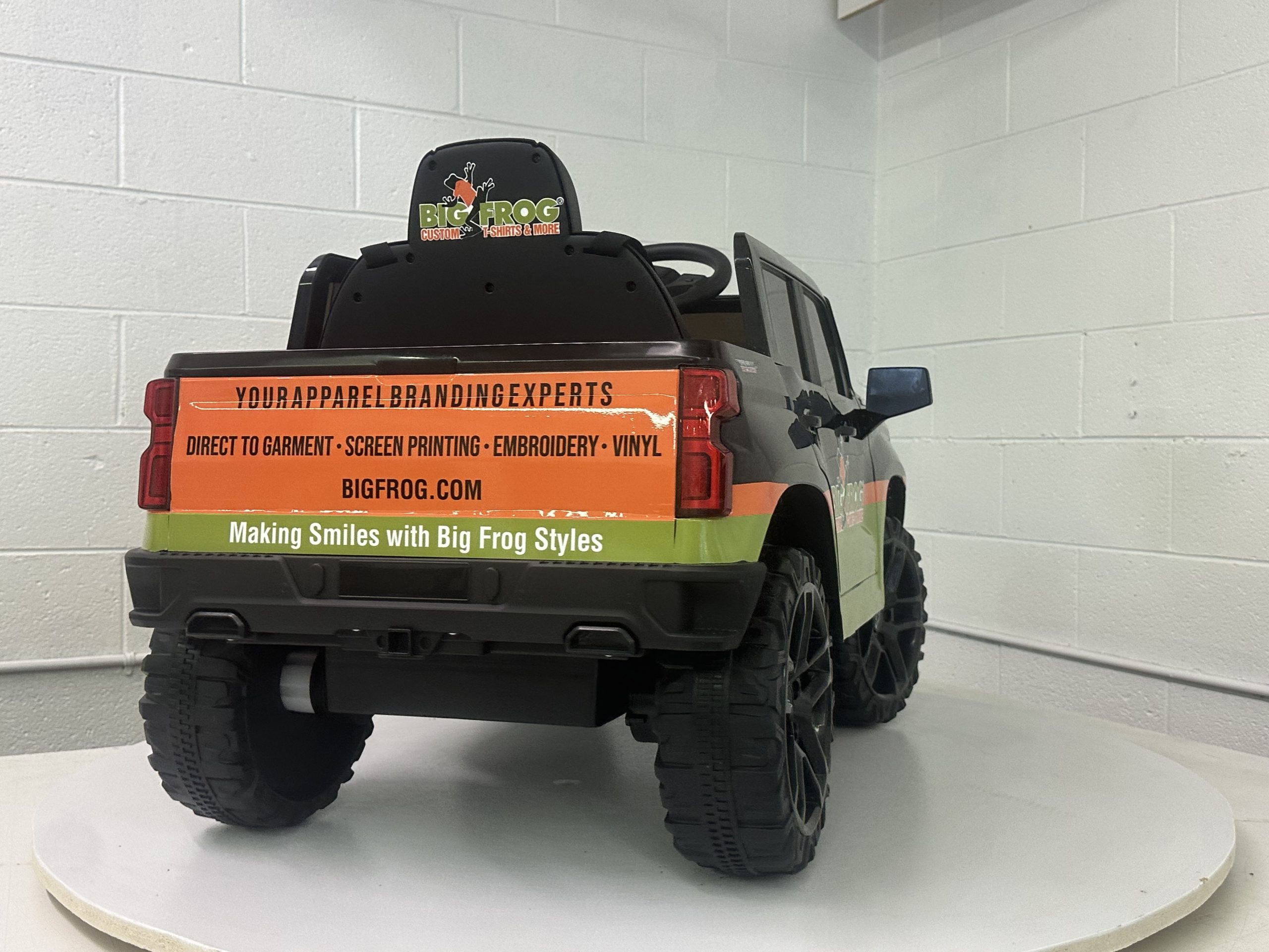 Custom branded toy truck promoting Big Frogs apparel and signage services.